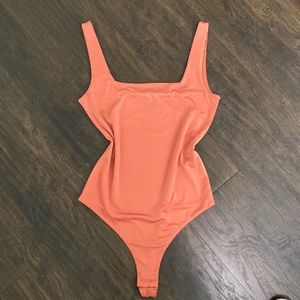 Peach square neck bodysuit in size M.